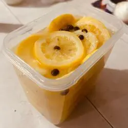 lemon slices with salt and pepper submerged in lemon juice
